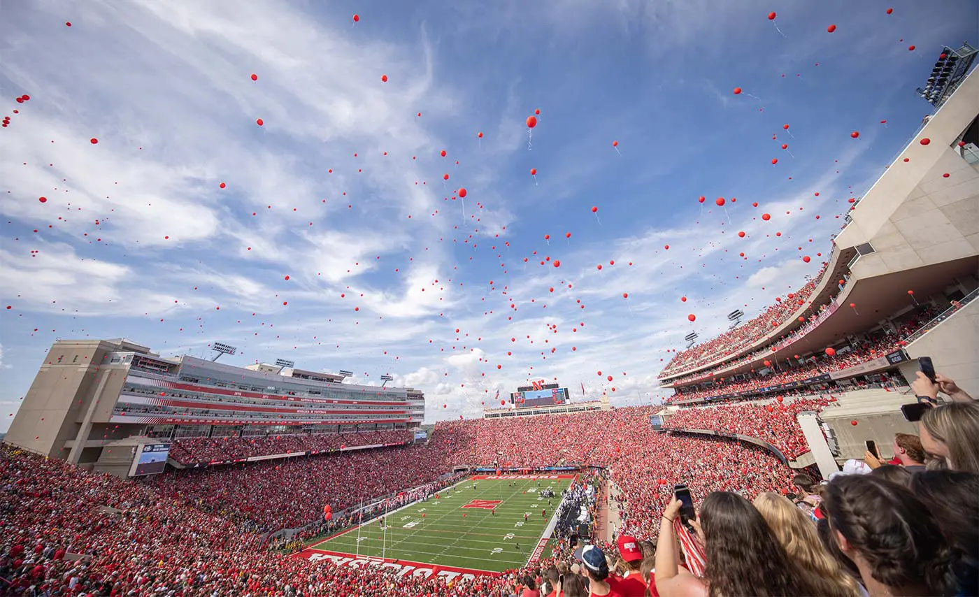 Full stadium with red balloons in the air